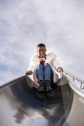 Portrait of happy young man on a slide - AFVF04657