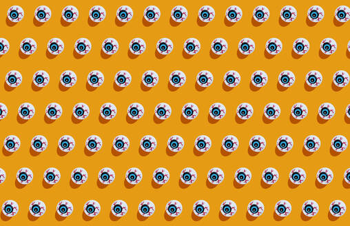 Fake scary eyeballs for halloween on orange background - GEMF03378