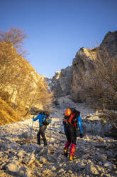 Two hikers beginning the ascent to the mountain, Orobie Alps, Lecco, Italy - MCVF00145