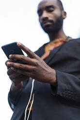 Hand of businessman holding smartphone, close-up - JSRF00699