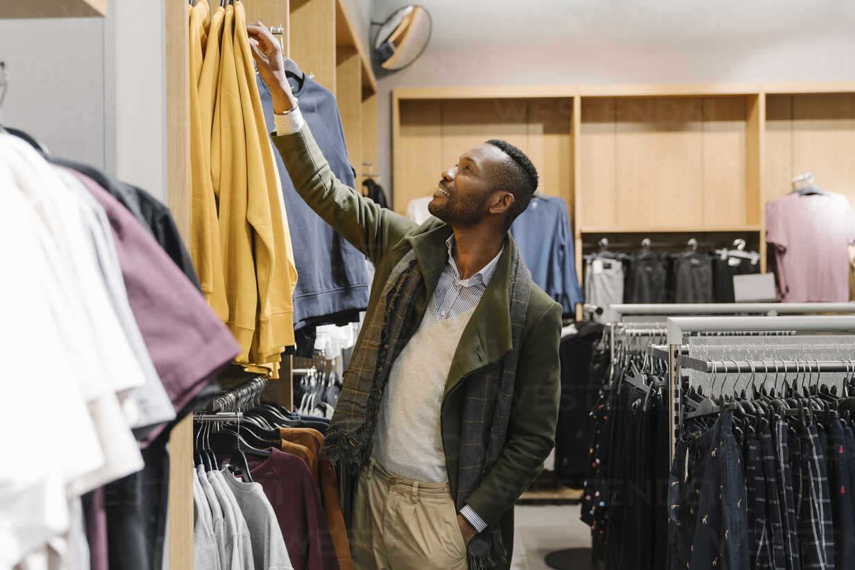 Stylish man shopping in a clothes store stock photo