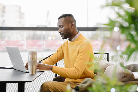 Businessman using laptop in a cafe stock photo