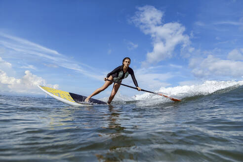 Female SUP surfer, Bali, Indonesia - KNTF03887