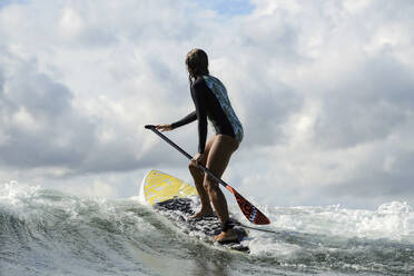 Female SUP surfer, Bali, Indonesia - KNTF03892