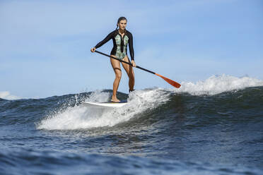 Female SUP surfer, Bali, Indonesia - KNTF03893