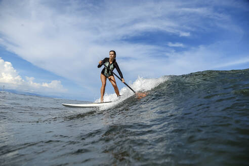 Female SUP surfer, Bali, Indonesia - KNTF03894