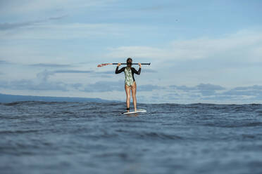 Female SUP surfer, Bali, Indonesia - KNTF03910