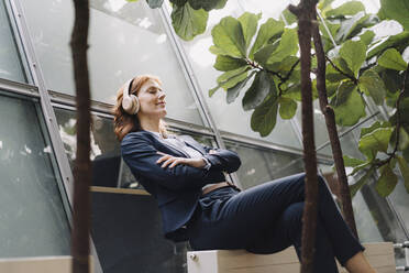 Businesswoman having a break in a modern office building - JOSF04182