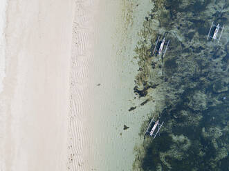 Indonesia, Bali, Nusa Dua beach, Aerial view of outrigger boats anchored on sea - KNTF03941