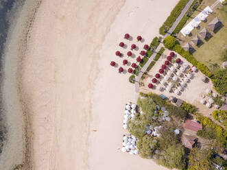 Indonesia, Bali, Nusa Dua, Aerial view of umbrellas on beach - KNTF03968