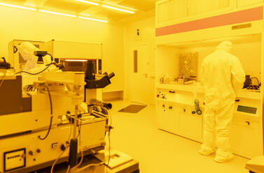 Wissenschaftlerin bei der Arbeit im Labor bei künstlichem gelbem Licht - AHSF01722