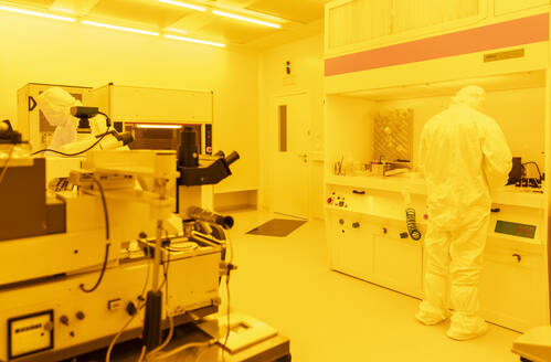 Scientist working in laboratory in artificial yellow light - AHSF01722