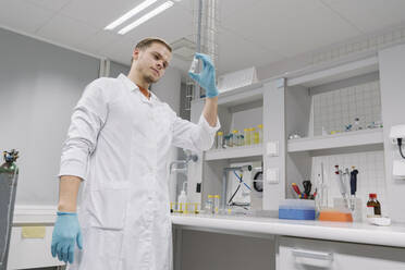 Scientist analyzing a specimen in laboratory - AHSF01812