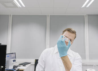 Scientist analyzing a specimen in laboratory - AHSF01814