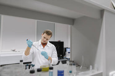 Scientist working with a pipette in laboratory - AHSF01815