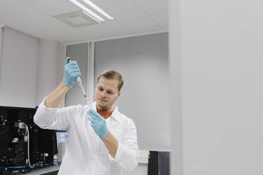 Scientist working with a pipette in laboratory - AHSF01816