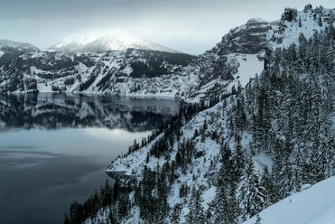 Scenic view of Crater Lake by snow covered mountains - CAVF72490
