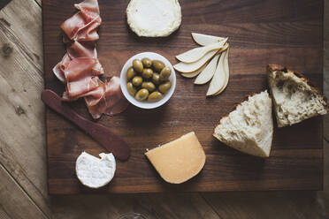 High angle view of food on cutting board over wooden table - CAVF72507