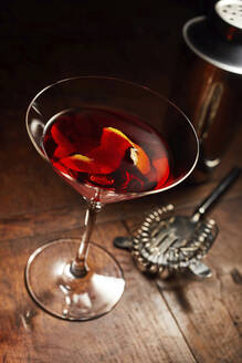 Martini or Manhattan drink with bar utensils on wooden counter - DREF00002