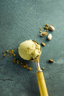 Pistachio ice cream on scoop and nuts - DREF00010