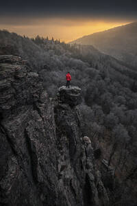 Man standing on rock needle at sunrise at Battert rock, Baden-Baden, Germany - MSUF00116