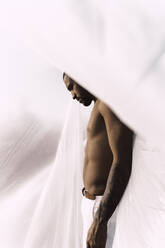 Barechested young man inside a plastic foil - ERRF02470