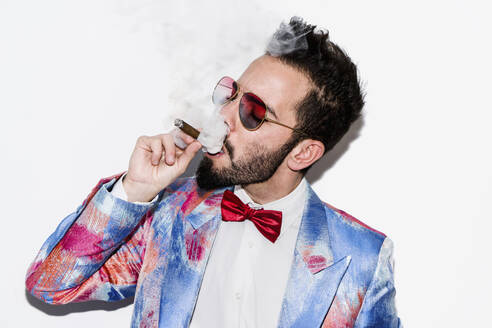 Cool and stylish man wearing a colorful suit and sunglasses and smoking a cigar - LOTF00083