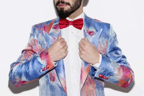 Stylish man wearing a colorful suit and a red bow tie stock photo