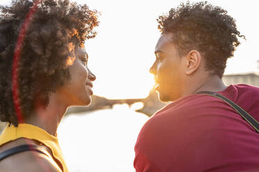 Happy young tourist couple in the city at sunset, Florence, Italy - FBAF01159