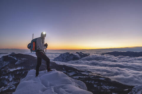 Mountaineer on the mountain summit during twilight, Orobie Alps, Lecco, Italy stock photo