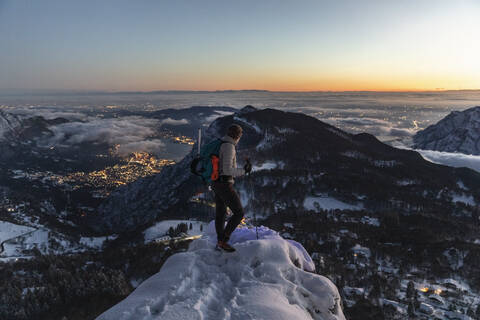 Mountaineer on the mountain summit during twilight, Orobie Alps, Lecco, Italy stock photo
