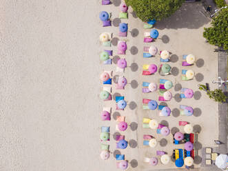 Indonesia, Bali, Nusa Dua, Aerial view of colorful umbrellas on resort beach - KNTF04049