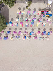 Indonesia, Bali, Nusa Dua, Aerial view of colorful umbrellas on resort beach - KNTF04050