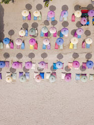 Indonesia, Bali, Nusa Dua, Aerial view of colorful umbrellas on resort beach - KNTF04054