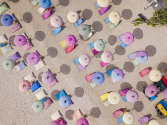 Indonesia, Bali, Nusa Dua, Aerial view of colorful umbrellas on resort beach - KNTF04057