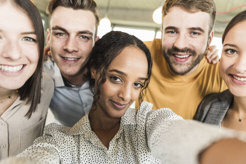 Group portrait of happy business people in office - UUF19898