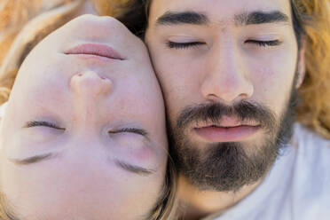 Young couple with closed eyes head to head, close-up - AFVF04909