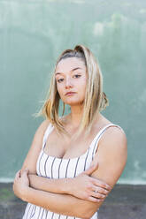 Portrait of blond young woman with arms crossed - AFVF04944