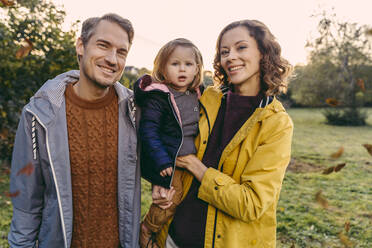 Portrait of happy family with daughter outdoors in autumn - MFF05034