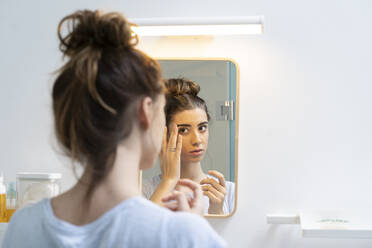 Rear view of young woman in bath room - ERRF02547