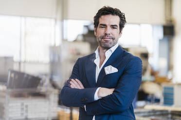 Portrait of a confident businessman in a factory - DIGF09043