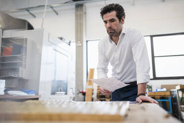 Portrait of a focused businessman in a factory - DIGF09052