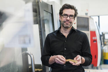 Portrait of a confident businessman in a factory - DIGF09095