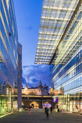 Germany, Berlin, Glass exteriors of Kurfurstendamm shopping malls at dusk - WDF05658