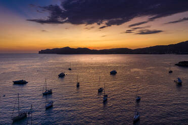 Spain, Mallorca, Santa Ponsa, Aerial view of boats floating in coastal water at dusk - AMF07693