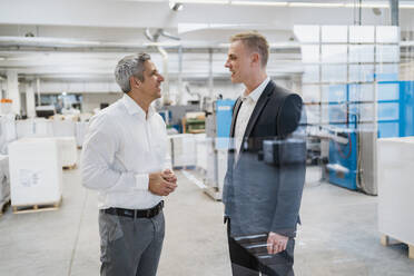 Two businessmen talking in a factory - DIGF09162