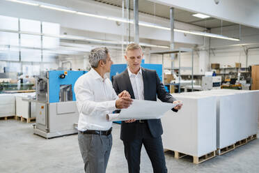 Two businessmen discussing a plan in a factory - DIGF09166