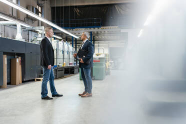 Two businessmen talking in a factory - DIGF09215