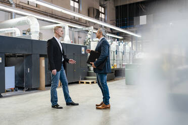 Two businessmen talking in a factory - DIGF09216