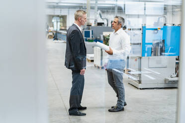 Two businessmen talking in a factory - DIGF09260